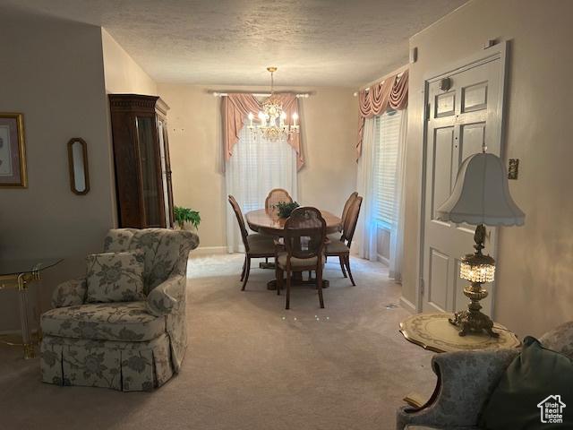 1567 E Westminster Ave, Salt Lake City, UT 84105 - carpeted dining room with a chandelier and a textured ceiling