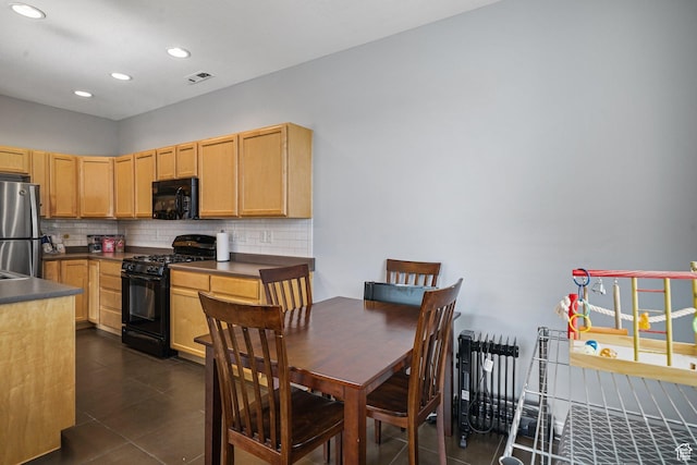 1051 W Castleton Dr, North Salt Lake, UT 84054 - kitchen with black appliances, backsplash, dark countertops, dark tile patterned floors, and recessed lighting