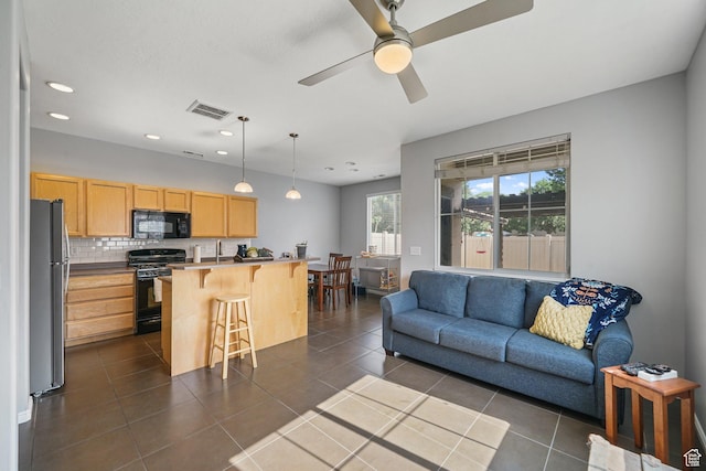 1051 W Castleton Dr, North Salt Lake, UT 84054 - living room featuring a ceiling fan, recessed lighting, and dark tile patterned floors