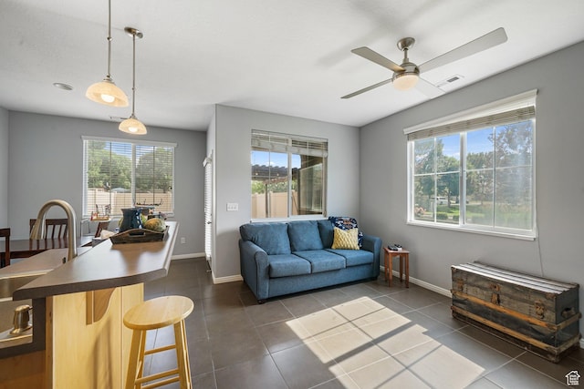 1051 W Castleton Dr, North Salt Lake, UT 84054 - living area featuring dark tile patterned flooring and ceiling fan