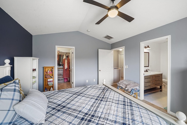 1051 W Castleton Dr, North Salt Lake, UT 84054 - carpeted bedroom with a walk in closet, vaulted ceiling, a closet, ensuite bath, and a ceiling fan