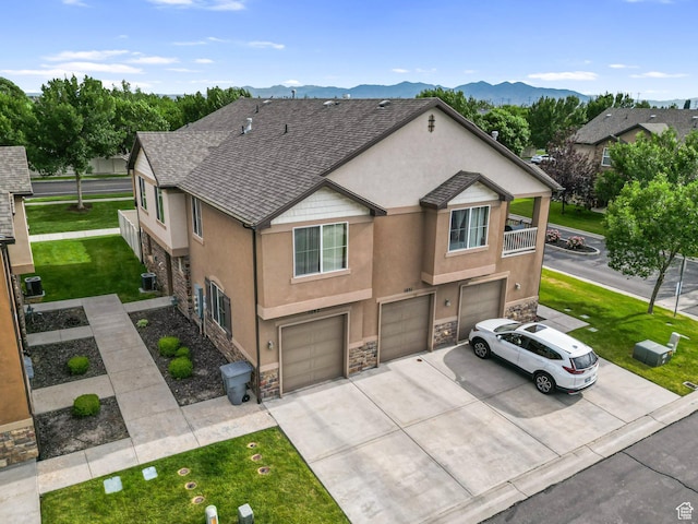 1051 W Castleton Dr, North Salt Lake, UT 84054 - view of property featuring stone siding, stucco siding, an attached garage, and concrete driveway