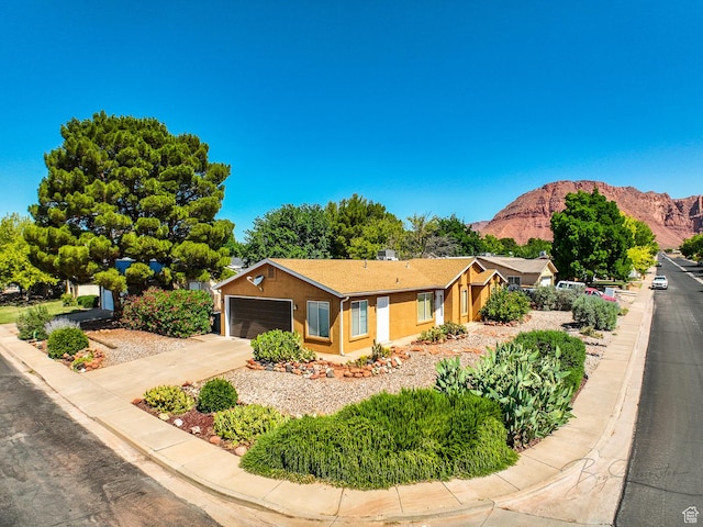 562 S 400 E, Ivins, UT 84738 - ranch-style home with a mountain view, driveway, an attached garage, and stucco siding