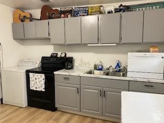 856 N 600 E, Lehi, UT 84043 - kitchen with black range with electric cooktop, gray cabinets, washer / dryer, and light wood-style flooring