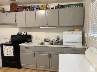 856 N 600 E, Lehi, UT 84043 - kitchen featuring black electric range, gray cabinets, washer / clothes dryer, light countertops, and light wood-style floors