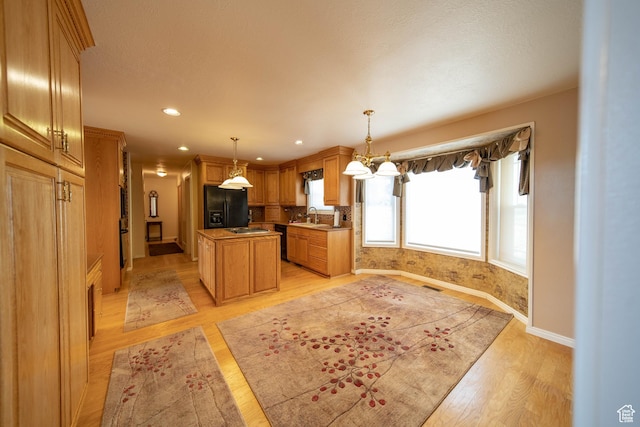1416 W Valley View Dr, Wellington, UT 84542 - kitchen with black appliances, light wood finished floors, a center island, hanging light fixtures, and recessed lighting