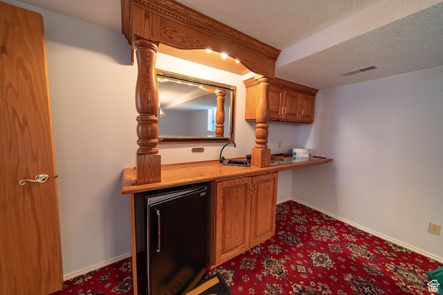1416 W Valley View Dr, Wellington, UT 84542 - bar area with refrigerator, carpet, and a textured ceiling