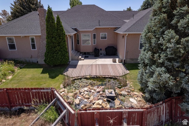1416 W Valley View Dr, Wellington, UT 84542 - rear view of house with a chimney, a deck, stucco siding, and a shingled roof