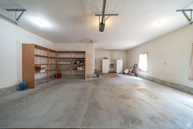 1416 W Valley View Dr, Wellington, UT 84542 - garage with freestanding refrigerator and a garage door opener