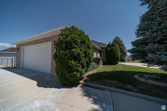 1416 W Valley View Dr, Wellington, UT 84542 - view of home's exterior with a lawn, brick siding, and a garage