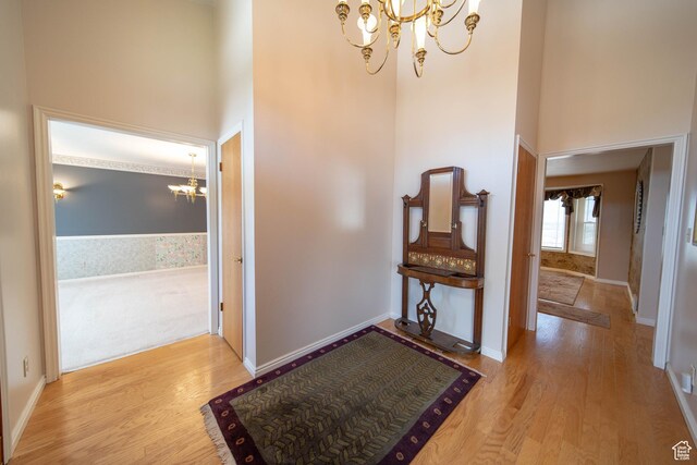 1416 W Valley View Dr, Wellington, UT 84542 - foyer entrance featuring a chandelier, a high ceiling, and wood finished floors
