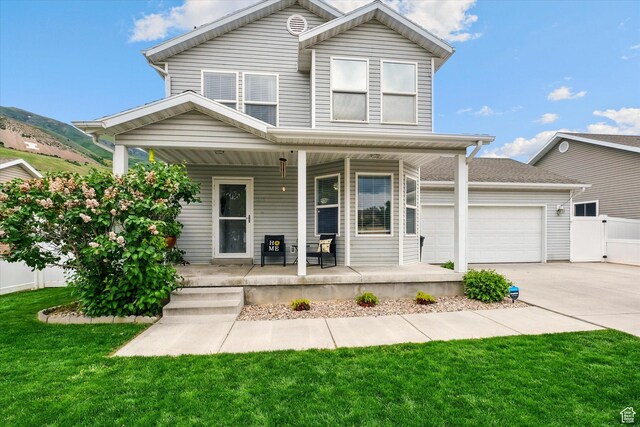 478 E 900 S, Brigham City, UT 84302 - traditional-style home with a porch, concrete driveway, and a garage