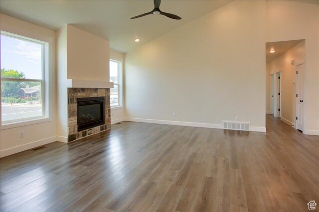 4181 W 1725 S, West Haven, UT 84401 - unfurnished living room with vaulted ceiling, a ceiling fan, wood finished floors, a stone fireplace, and recessed lighting
