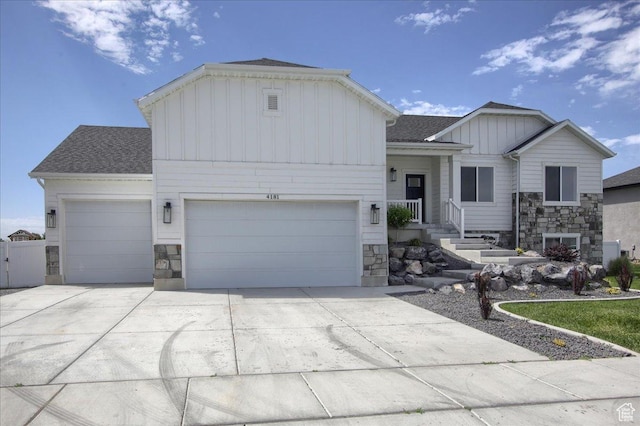 4181 W 1725 S, West Haven, UT 84401 - view of front facade with board and batten siding, stone siding, an attached garage, and concrete driveway