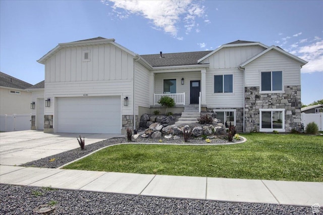 4181 W 1725 S, West Haven, UT 84401 - view of front of property featuring board and batten siding, stone siding, an attached garage, and driveway