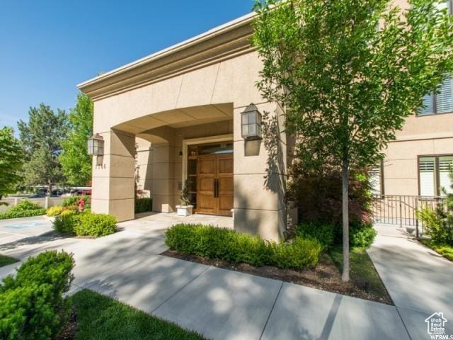 1706 E Murray Holladay Rd S Unit 204, Holladay, UT 84117 - doorway to property featuring stucco siding