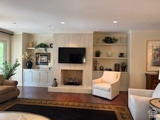 1706 E Murray Holladay Rd S Unit 204, Holladay, UT 84117 - living area with a fireplace with raised hearth, built in shelves, and recessed lighting
