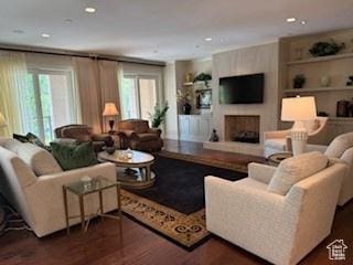 1706 E Murray Holladay Rd S Unit 204, Holladay, UT 84117 - living area featuring dark wood finished floors, healthy amount of natural light, built in features, and recessed lighting