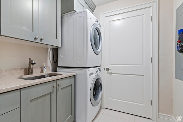 1706 E Murray Holladay Rd S Unit 204, Holladay, UT 84117 - laundry room with stacked washer / drying machine, cabinet space, and light tile patterned floors