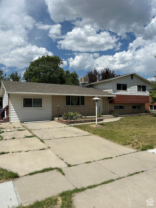 2784 W 2890 S, West Valley City, UT 84119 - tri-level home featuring concrete driveway and a front yard
