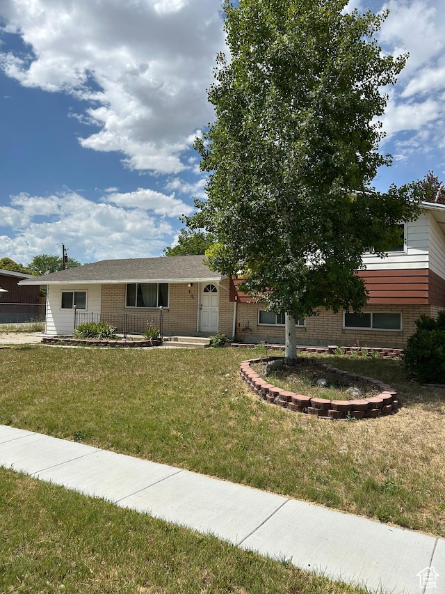 2784 W 2890 S, West Valley City, UT 84119 - view of front of home featuring brick siding and a front yard