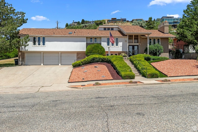 771 E 17th Ave, Salt Lake City, UT 84103 - view of front facade with brick siding, stairs, and concrete driveway
