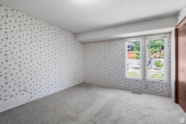 771 E 17th Ave, Salt Lake City, UT 84103 - unfurnished room featuring wallpapered walls, carpet, and a textured ceiling
