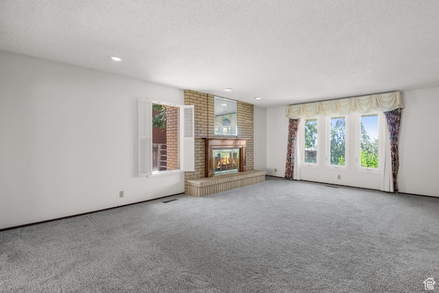 771 E 17th Ave, Salt Lake City, UT 84103 - unfurnished living room featuring a textured ceiling, carpet flooring, a brick fireplace, and recessed lighting