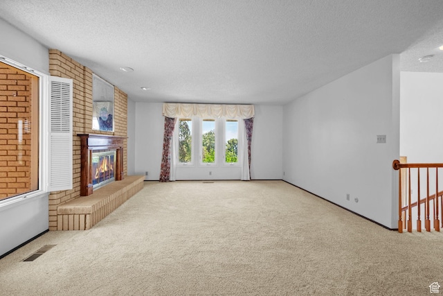 771 E 17th Ave, Salt Lake City, UT 84103 - unfurnished living room with a textured ceiling, carpet flooring, and a brick fireplace