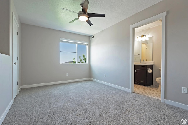 5306 W Solafax Ln, Herriman, UT 84096 - unfurnished bedroom with carpet floors, connected bathroom, a textured ceiling, and a ceiling fan