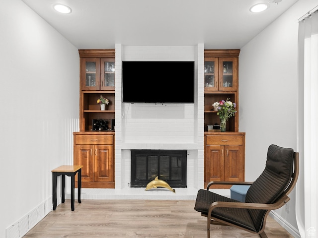 5423 S Tonalea Dr, Murray, UT 84107 - living area featuring a brick fireplace, light wood-type flooring, and recessed lighting
