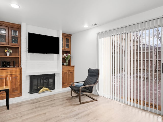 5423 S Tonalea Dr, Murray, UT 84107 - sitting room with wood finished floors, a brick fireplace, and recessed lighting