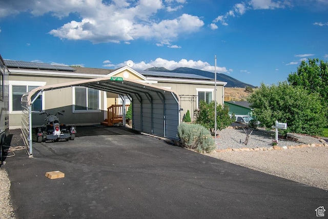 305 S Sheridan St, Stockton, UT 84071 - view of front of property with asphalt driveway, a carport, a mountain view, and solar panels