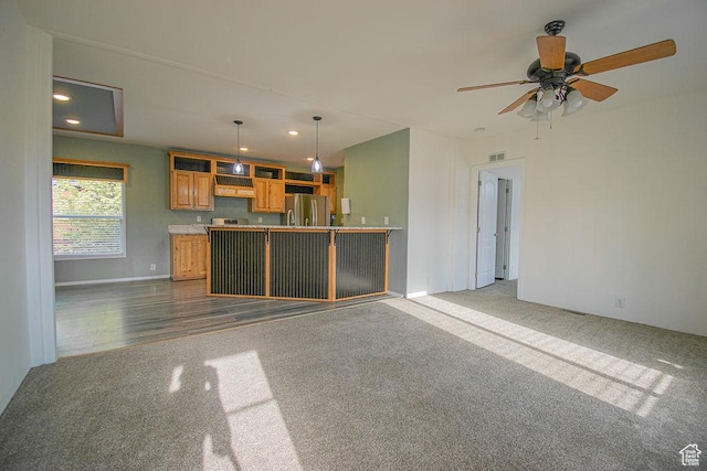 305 S Sheridan St, Stockton, UT 84071 - unfurnished living room with carpet, recessed lighting, a ceiling fan, and wood finished floors