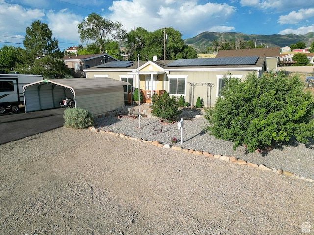 305 S Sheridan St, Stockton, UT 84071 - ranch-style house featuring a mountain view, a detached carport, and solar panels