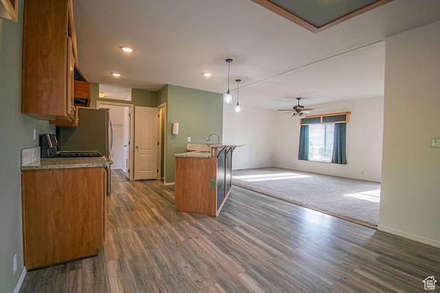305 S Sheridan St, Stockton, UT 84071 - kitchen with brown cabinetry, dark wood-style floors, ceiling fan, recessed lighting, and decorative light fixtures