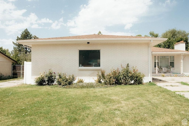 571 E Center St, Kaysville, UT 84037 - view of side of property featuring brick siding, a lawn, and a chimney