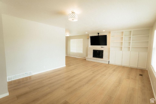 571 E Center St, Kaysville, UT 84037 - unfurnished living room featuring light wood finished floors and a fireplace