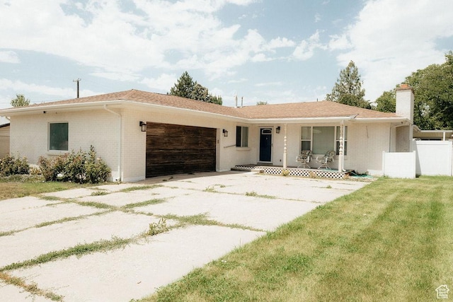 571 E Center St, Kaysville, UT 84037 - ranch-style house with a garage, a porch, a chimney, brick siding, and driveway
