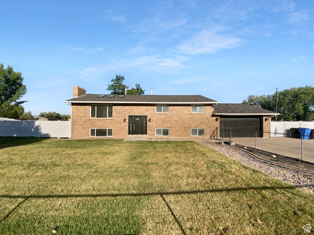 1175 N 1100 W, West Bountiful, UT 84087 - back of property featuring driveway, a chimney, brick siding, and an attached garage