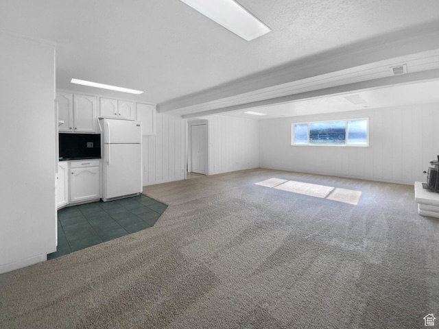 1175 N 1100 W, West Bountiful, UT 84087 - unfurnished living room featuring a wood stove, carpet floors, and tile patterned floors