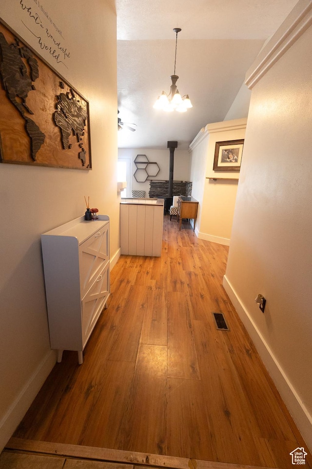 2673 S 2400 W, Weston, ID 83286 - hall featuring light wood-style floors and a chandelier