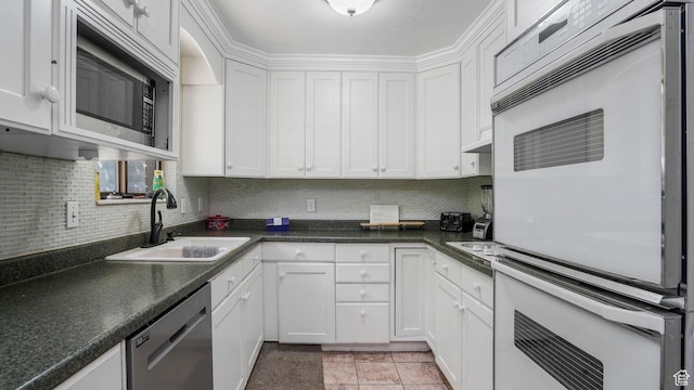 11778 S 1700 E, Sandy, UT 84092 - kitchen with stainless steel appliances, white cabinetry, decorative backsplash, and dark countertops