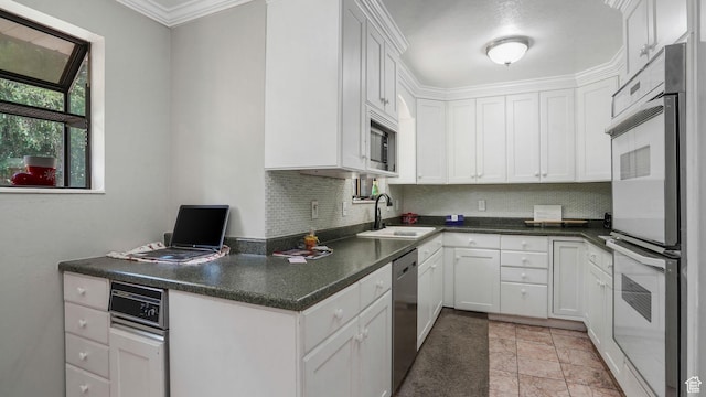 11778 S 1700 E, Sandy, UT 84092 - kitchen with stainless steel appliances, backsplash, white cabinets, crown molding, and dark countertops