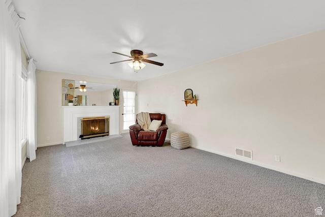 506 N 100 E, Brigham City, UT 84302 - living area featuring carpet, a ceiling fan, and a warm lit fireplace