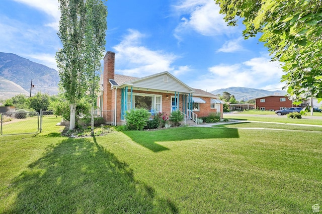 506 N 100 E, Brigham City, UT 84302 - bungalow-style house with a mountain view, a chimney, brick siding, and a gate