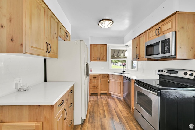 506 N 100 E, Brigham City, UT 84302 - kitchen with appliances with stainless steel finishes, light wood finished floors, light countertops, and light brown cabinetry