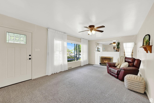 506 N 100 E, Brigham City, UT 84302 - living room featuring ceiling fan, a lit fireplace, and carpet flooring