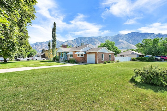 506 N 100 E, Brigham City, UT 84302 - view of front facade with a garage, brick siding, a mountain view, and a chimney