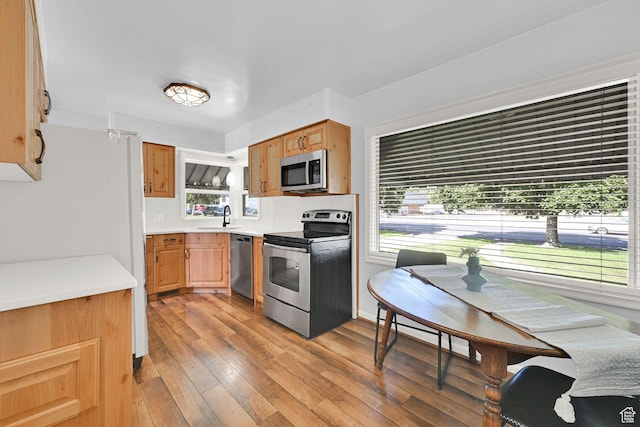 506 N 100 E, Brigham City, UT 84302 - kitchen featuring appliances with stainless steel finishes, light wood-type flooring, and light countertops